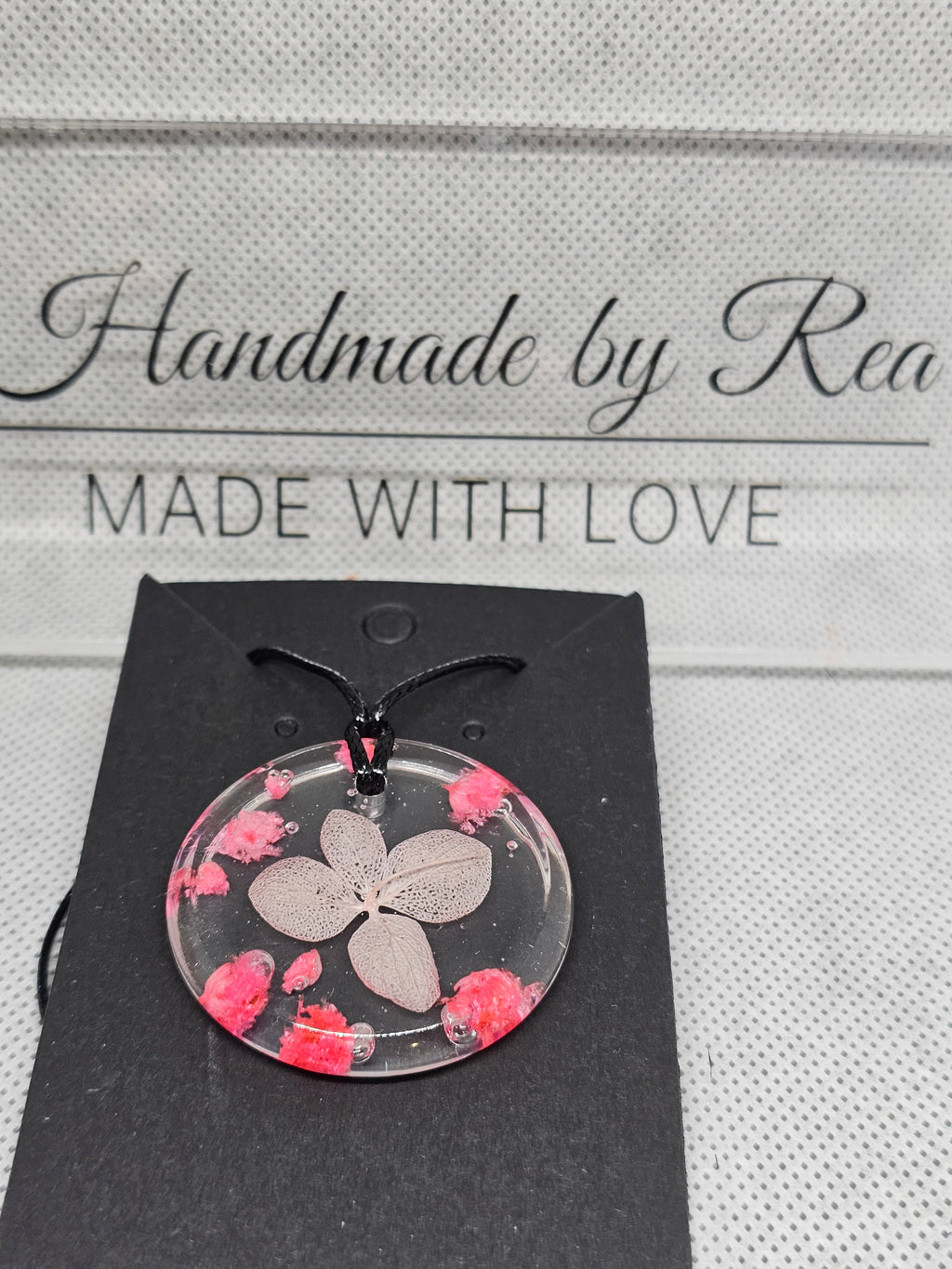 Clear Resin Necklace with Skeleton Leaf & Pink Flowers – Round Pendant