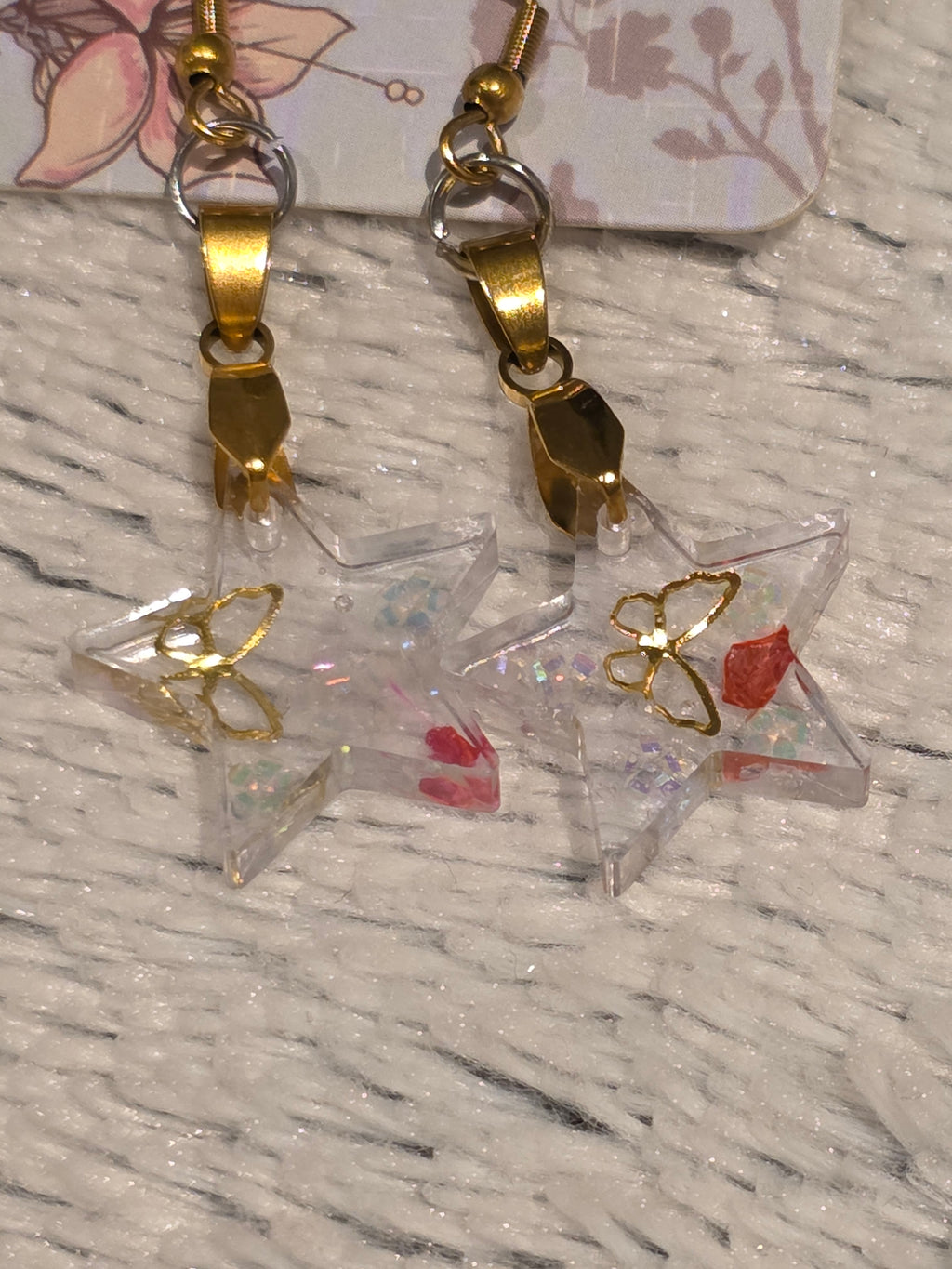 Resin earrings – clear star charms with gold detail and glitter effect