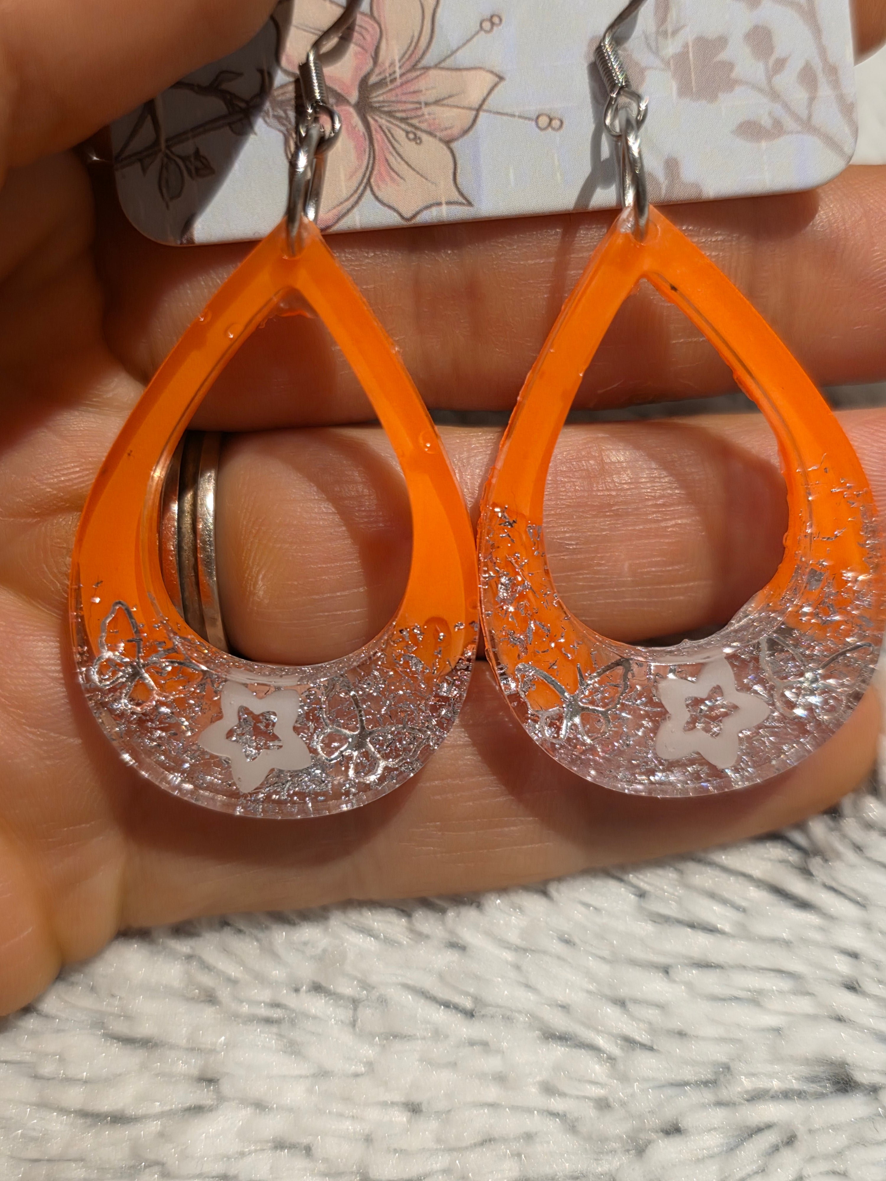 Resin earrings – orange hoops with silver star glitter effect, stainless-steel hooks