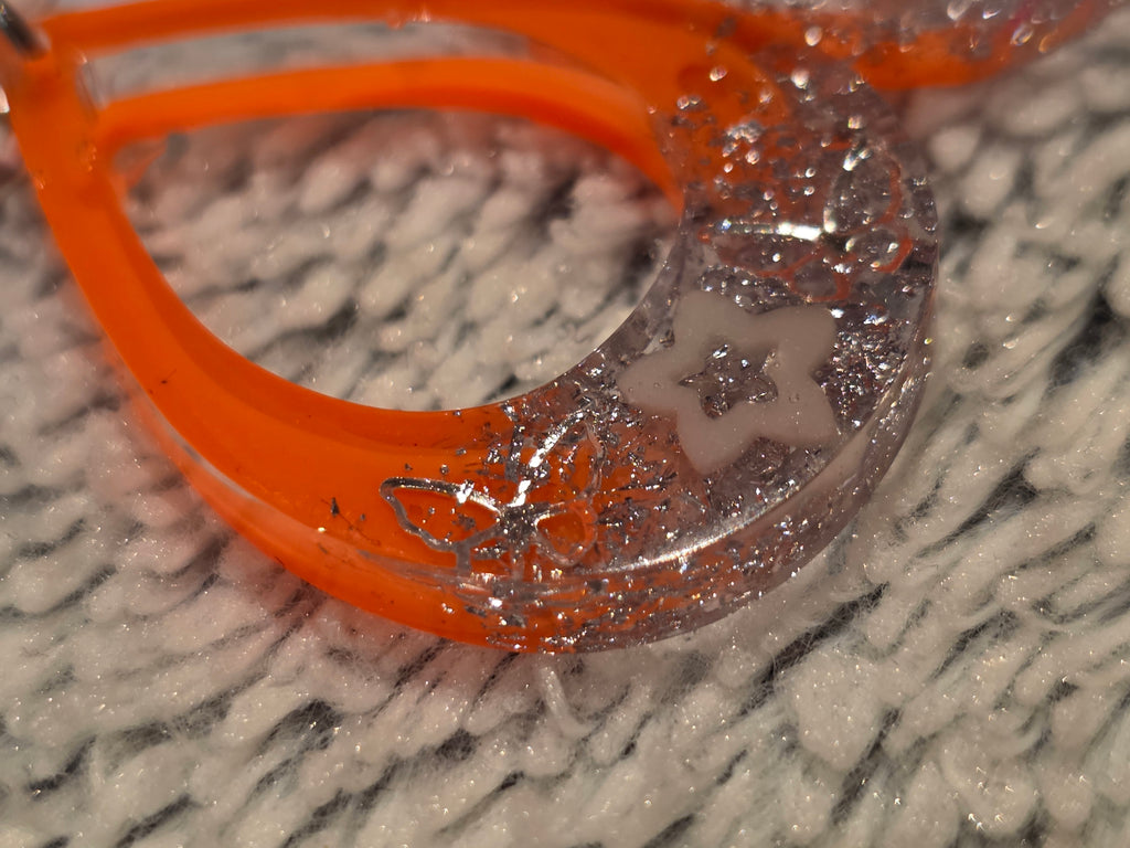 Resin earrings – orange hoops with silver star glitter effect, stainless-steel hooks