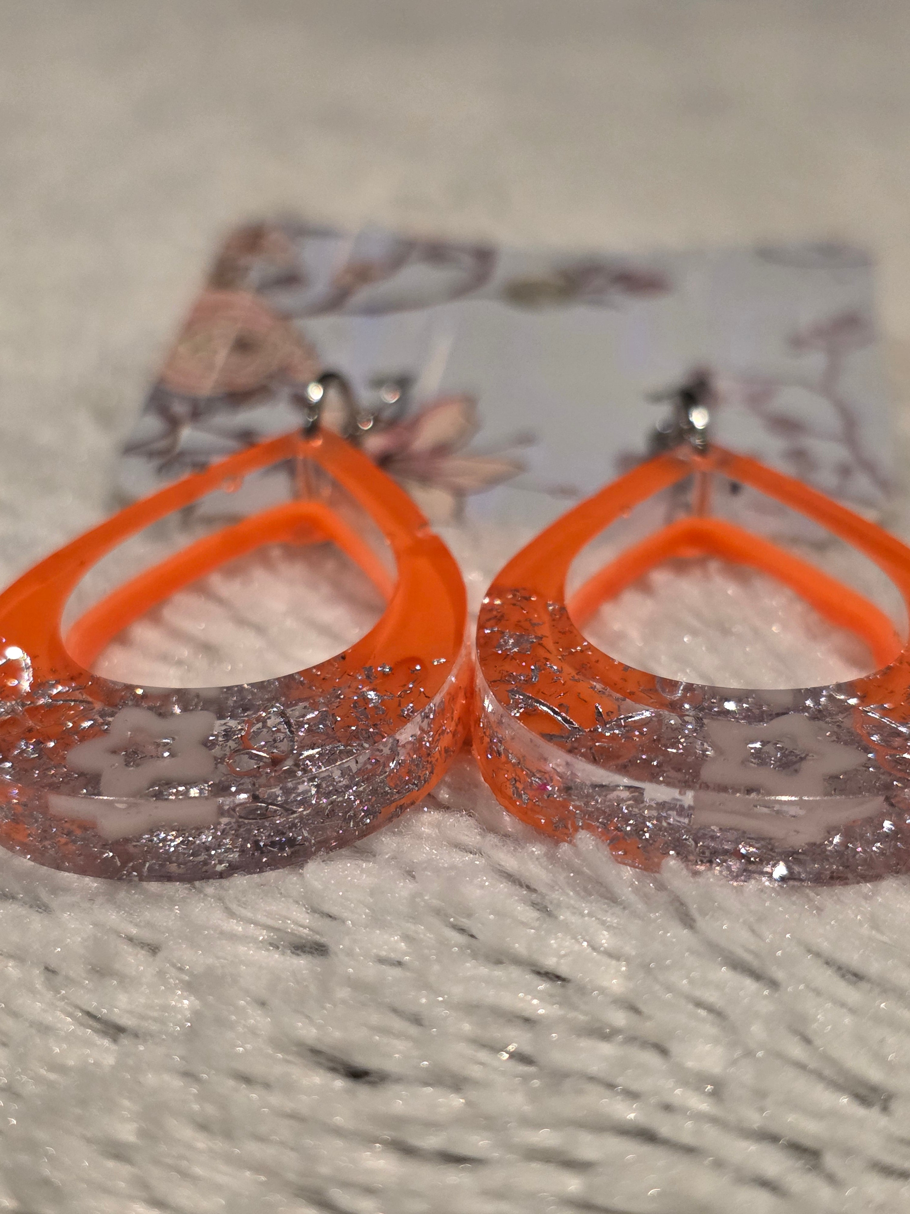 Resin earrings – orange hoops with silver star glitter effect, stainless-steel hooks